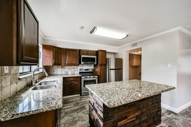 Kitchen features granite counter tops and stainles