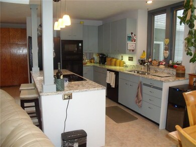 Open kitchen area, top-of-the-line appliances stay