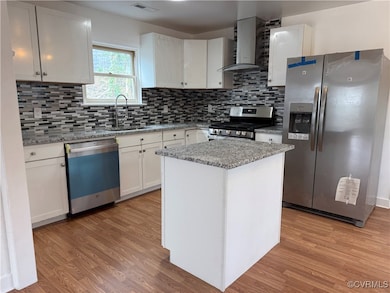 Kitchen featuring stainless steel appliances, ligh