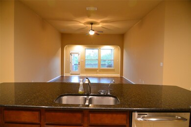 Kitchen featuring dishwasher, brown cabinetry, op