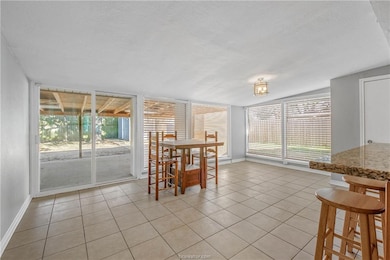Dining area featuring a textured ceiling and light