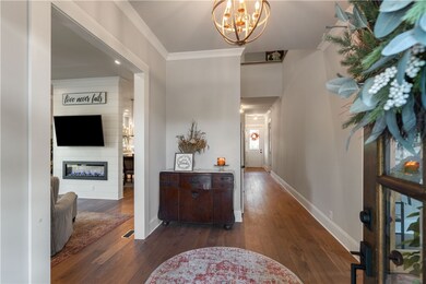 foyer with peek of the living room fireplace wall