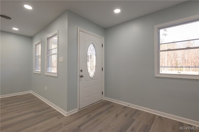 Entrance foyer with wood finished floors, recessed