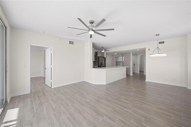 Unfurnished living room with ceiling fan and light