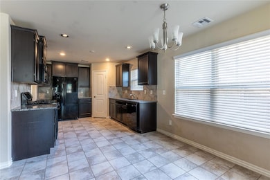 Kitchen with stone countertops, decorative light f