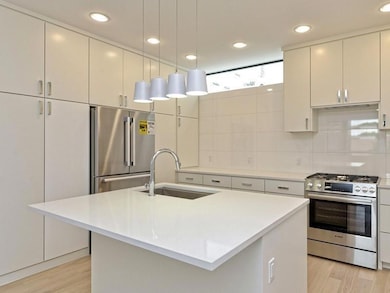 Kitchen featuring light wood-style floors, applia