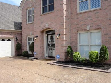 Up Close of Front Door with Brick Flower Beds