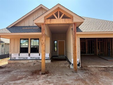 View of exterior entry with a shingled roof, board and batten siding, and an attached garage
