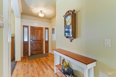 Foyer entrance featuring light wood-style flooring and baseboards