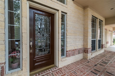 An inviting front porch offers a warm welcome and