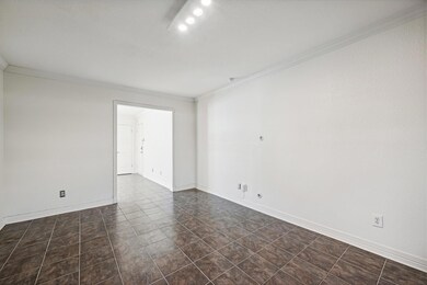 Unfurnished room with baseboards, crown molding, a