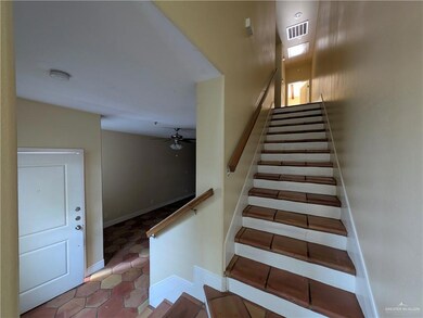 Stairway with tile patterned floors, a ceiling fan, and baseboards