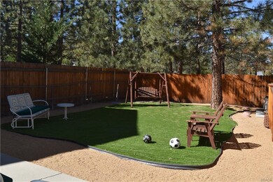Fully fenced, private rear yard with Astroturf for