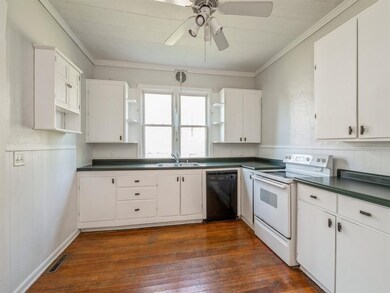 Hardwood floors in the bright white kitchen