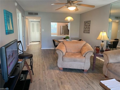 Living room with vinyl  flooring and ceiling fan