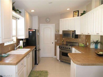 kitchen features stone counter tops, stainless ste