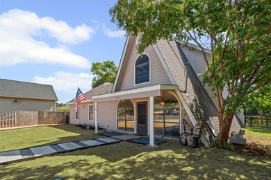 Rear view of property with roof with shingles and a patio area