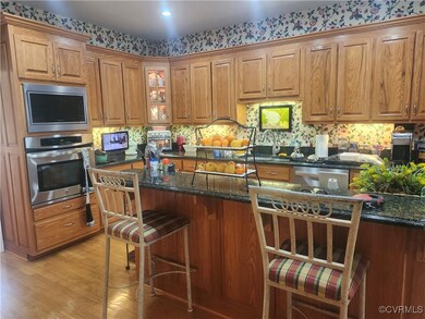 Kitchen with a kitchen bar, dark stone countertops
