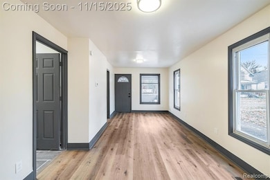 Entrance foyer featuring light wood-style floors and baseboards