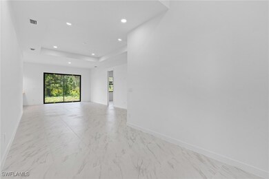 Empty room featuring marble finish floor, baseboar