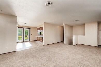 Living room looking into the dining and kitchen.
