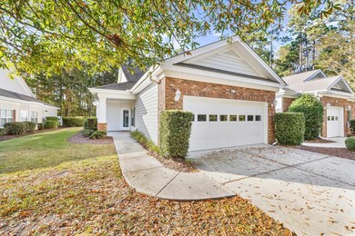 View of front of house with a front yard and a gar