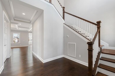 Grand 2 story foyer with beautiful hardwood and trim detail!