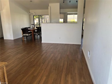 Dining room featuring dark wood-style floors and healthy amount of natural light