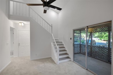 Staircase with a towering ceiling, carpet floors, 