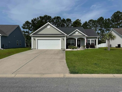 Ranch-style house featuring an attached garage, driveway, and covered porch