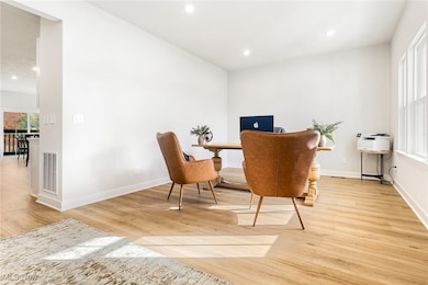 Home office featuring recessed lighting and light wood finished floors
