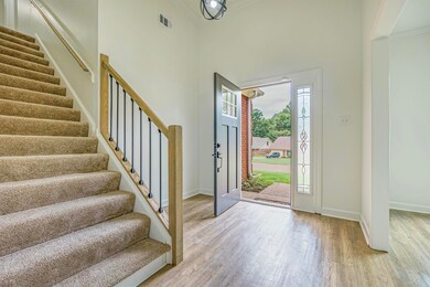 Entryway featuring a towering ceiling, crown moldi
