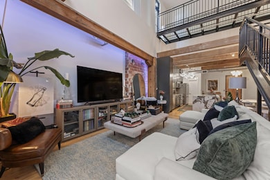 Living room featuring wood finished floors, arched