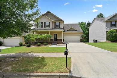 Craftsman inspired home with concrete driveway, brick siding, a front lawn, and an attached garage