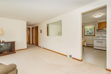 View of living room into kitchen and 3 bedrooms.