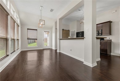 Unfurnished living room with vaulted ceiling, base