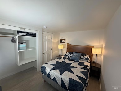 Bedroom featuring wood finished floors and baseboards