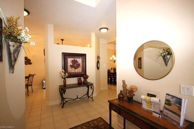 Hall featuring light tile patterned floors and a c