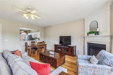 Living room featuring light wood-style floors, cei