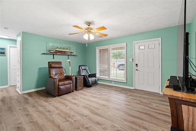 Sitting room featuring wood finished floors and ceiling fan