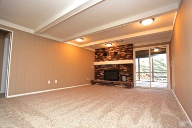 Living room w/ fireplace and entrance to the scree