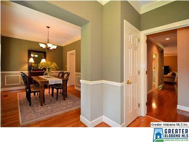 Entry shows off hard wood floors and warm neutral 