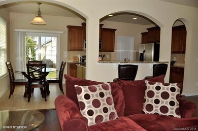 Family room with hardwood floors open to breakfast