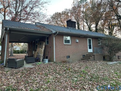 Back of house with a chimney, brick siding, crawl space, a patio, and entry steps