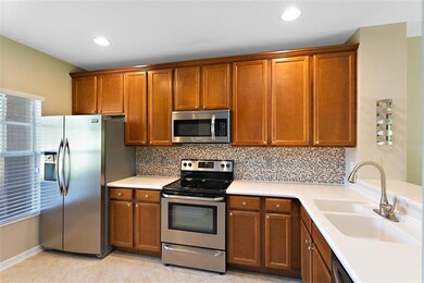 Kitchen-Boasts solid surface countertops, decorative glass tile backsplash, 42