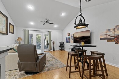 Living area with lofted ceiling, ceiling fan, woo