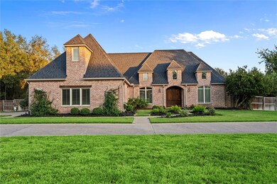 French country inspired facade featuring a front y