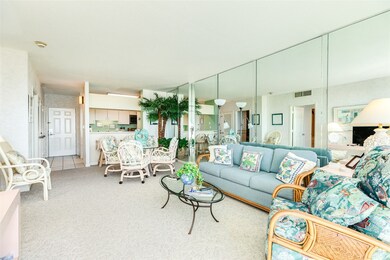 Living and dining to kitchen and foyer.