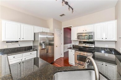Kitchen with granite counter tops and SS appliance