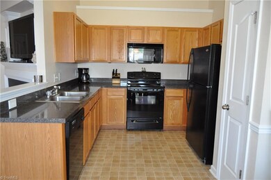 Open kitchen features matching appliances, garbage disposal, and pantry!